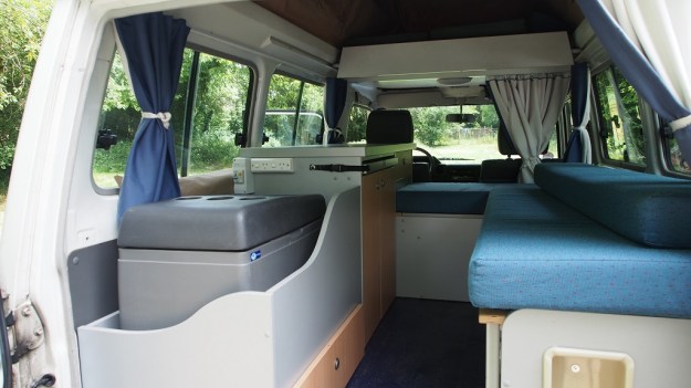 Ein Blick in das Innere unseres Landcruisers: hier werden wir 60 Tage lang leben, kochen, schlafen und rumkramen. Denn es gibt wenig Stauraum. Hinter den beiden Türen  links werden wir wohl Küchenutensilien und Vorräte verstauen. Unter den Sitzbänken ist praktisch kein Stauraum vorhanden, weil dort der von außen aufziehbare Kochbereich sowie Gasflasche, Wasserkanister usw. untergebracht sind. Also wird die zusammenklappbare Zahnbürste eingepackt und die Klamotten werden gewaschen und gleich wieder angezogen. Es gibt tolle Funktionskleidung, die im Nu trocknet.